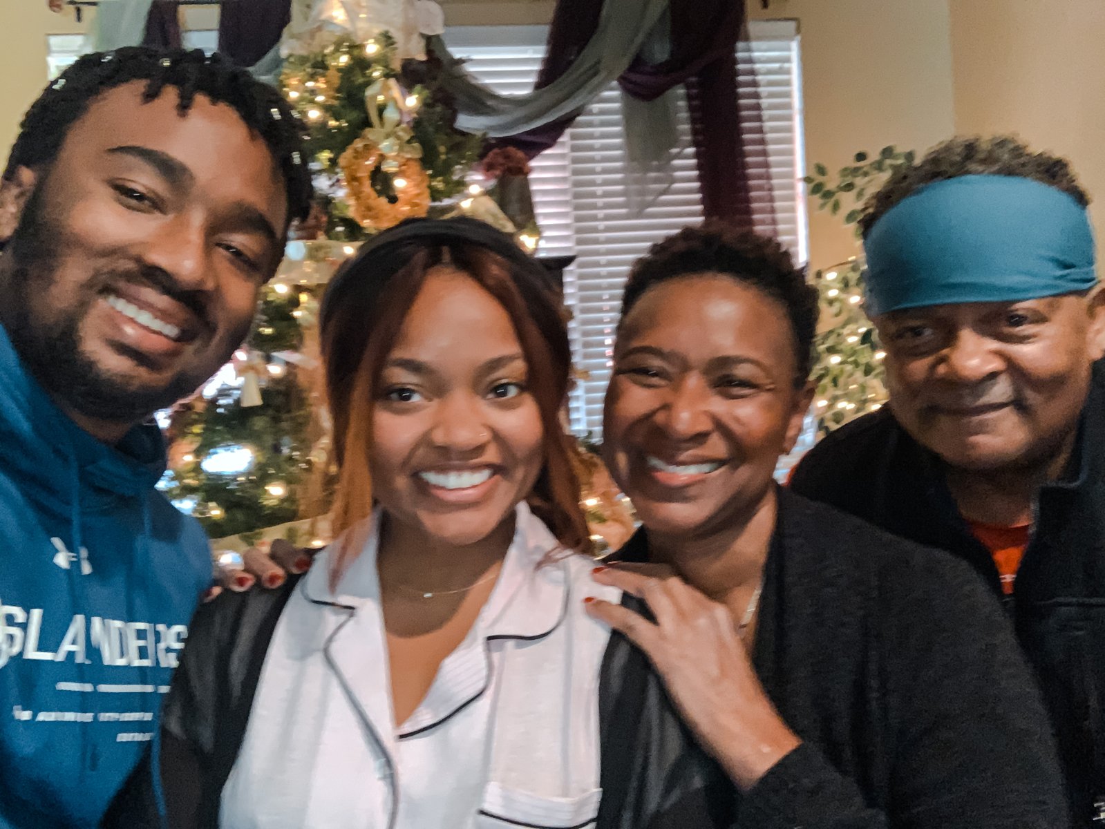 Family of four by the Christmas tree