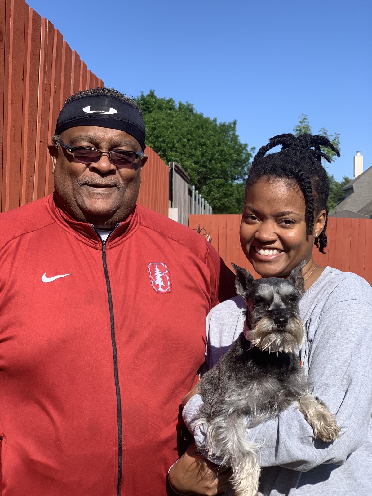 Michael and Gabriell holding a dog outside