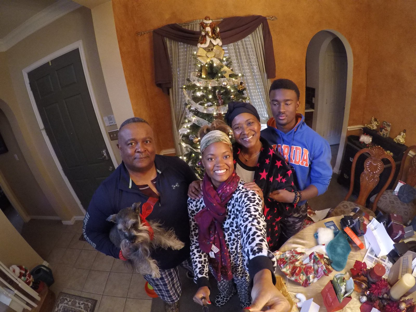 Family gathered by the tree with the dog